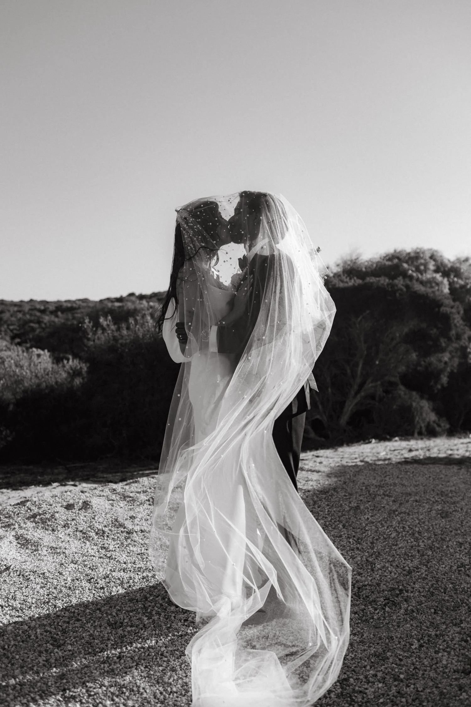 A bride and groom kissing in Bremer Bay