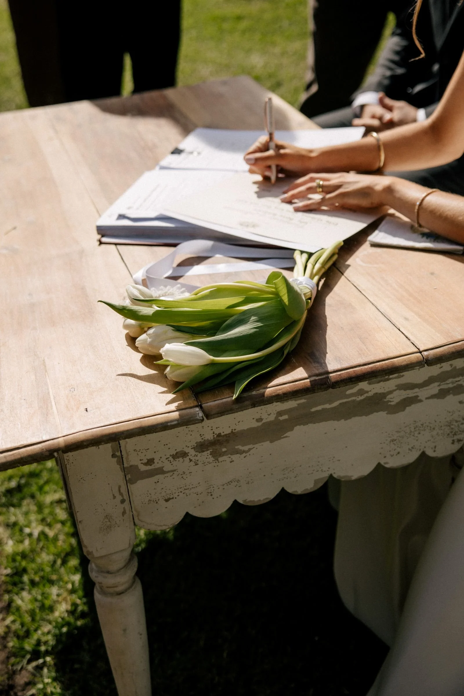 A bride signing her marriage certificate