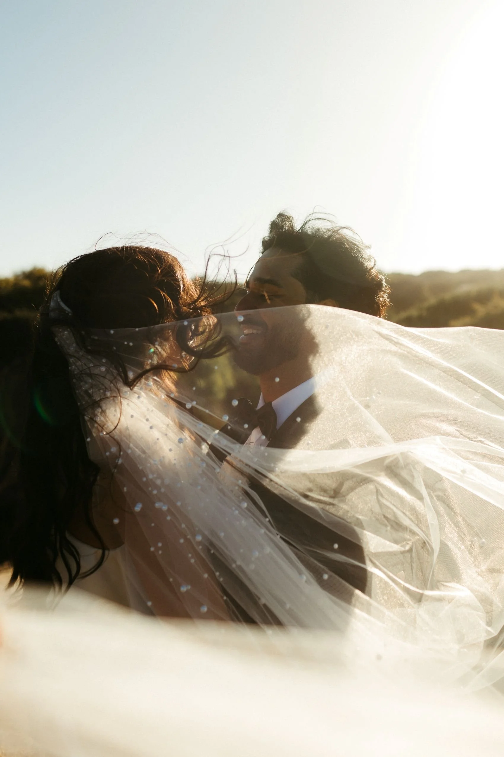 A bride and groom embracing as classial music plays