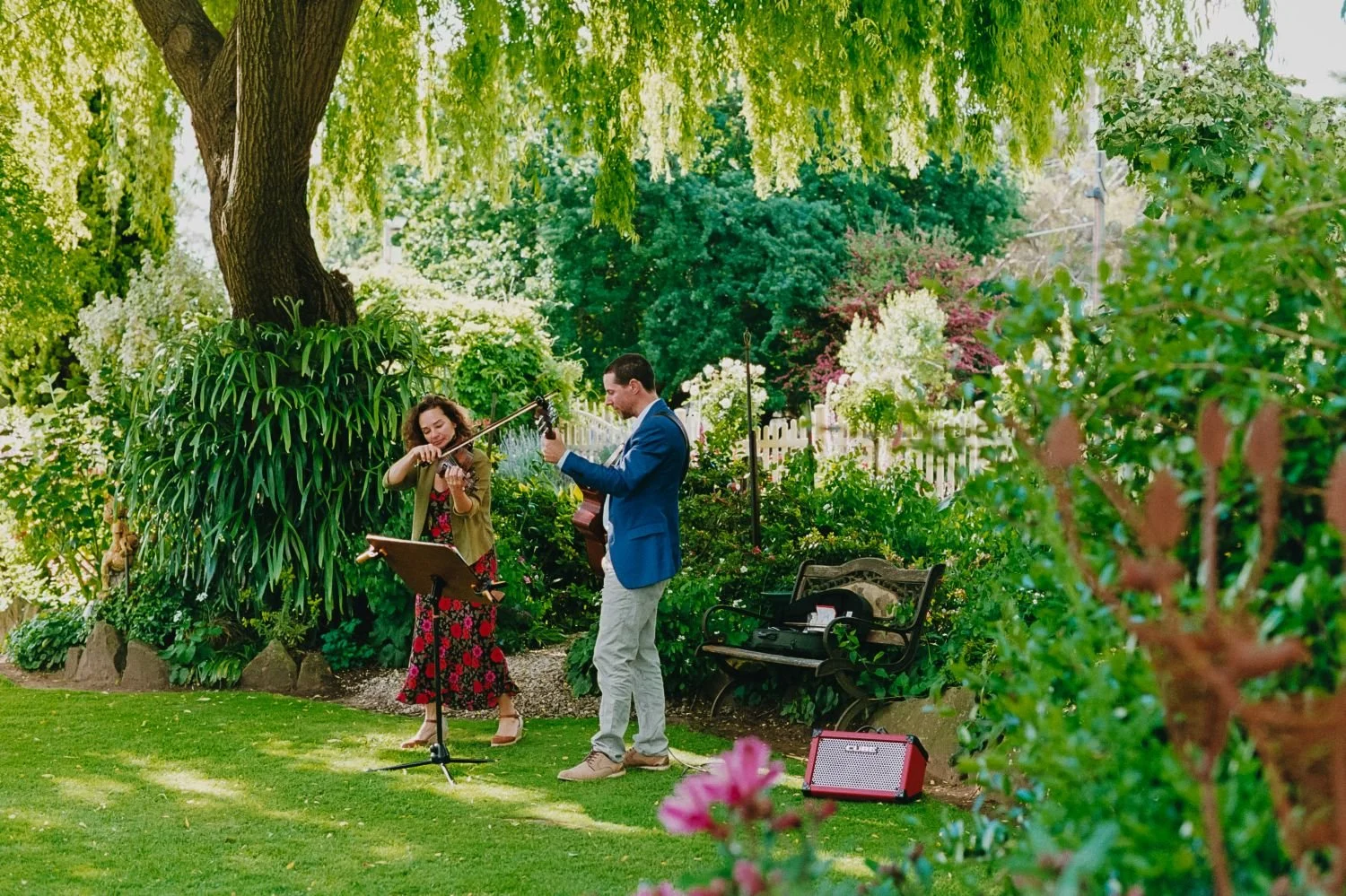 Two professional wedding musicians playing ceremony music in a beautiful garden in Albany Western Australia