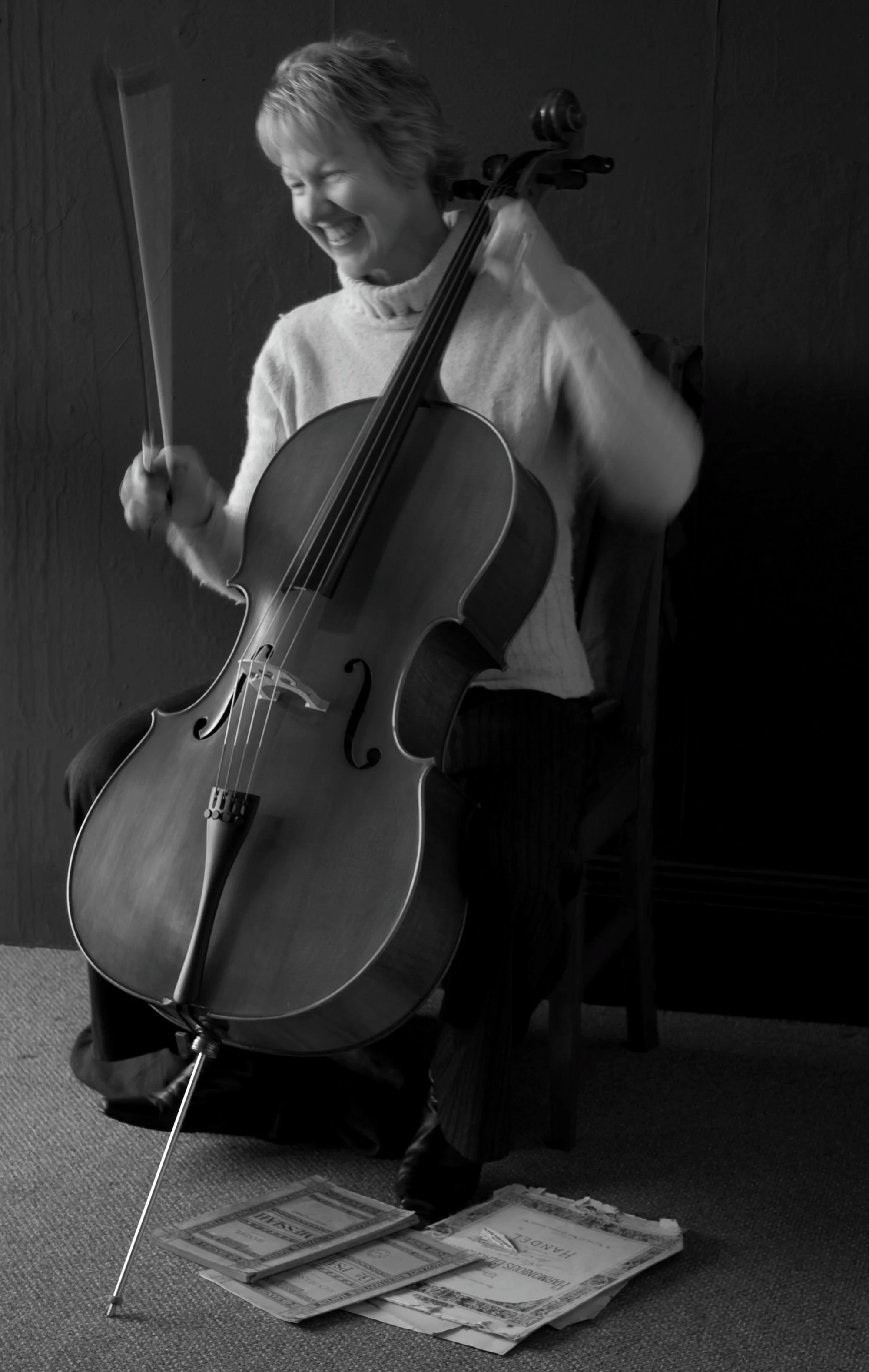 Albany Cello player Julie Parish holding her cello and smiling