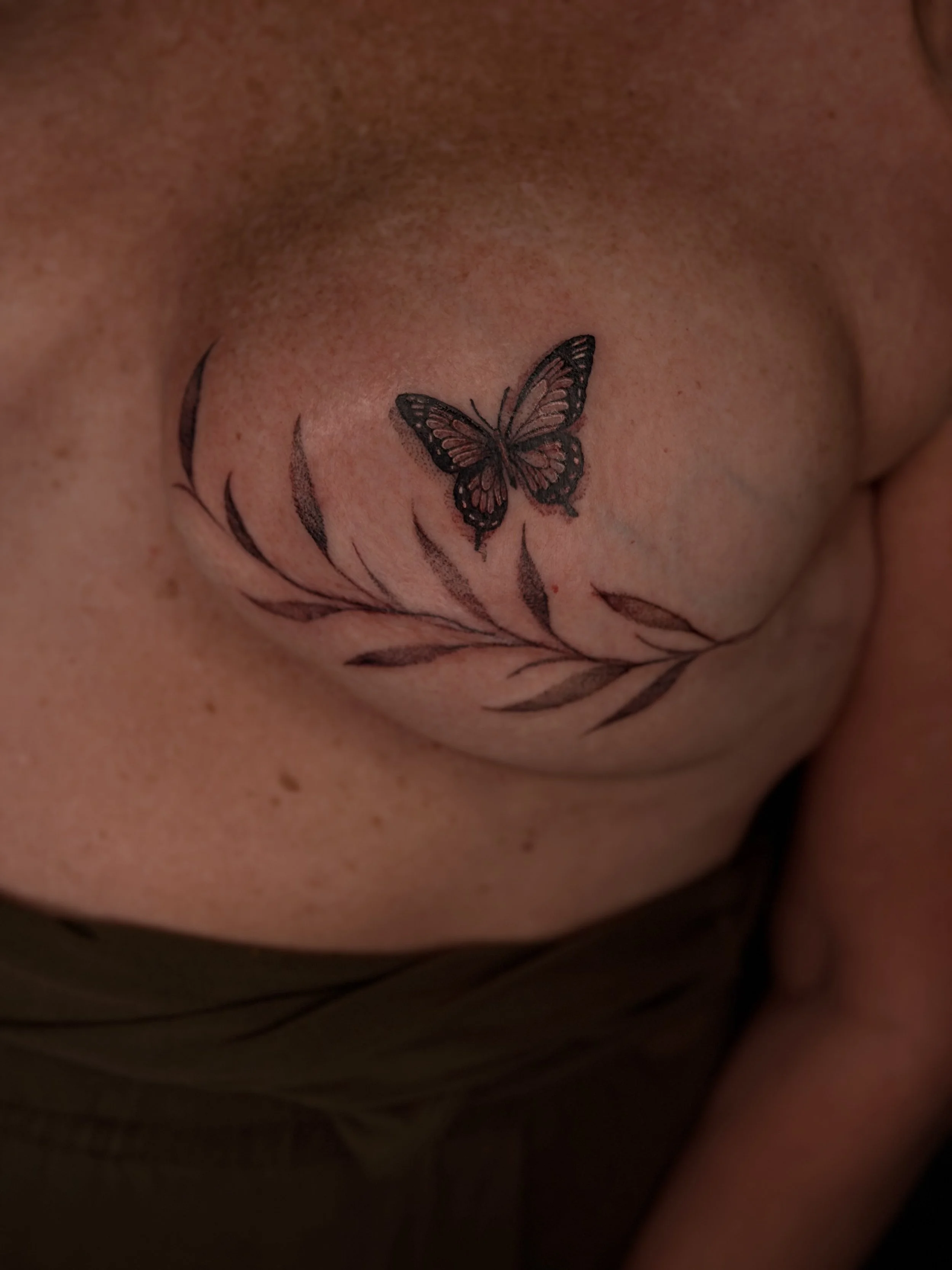 Freehand vine and butterfly tattoo on mastectomy scars
