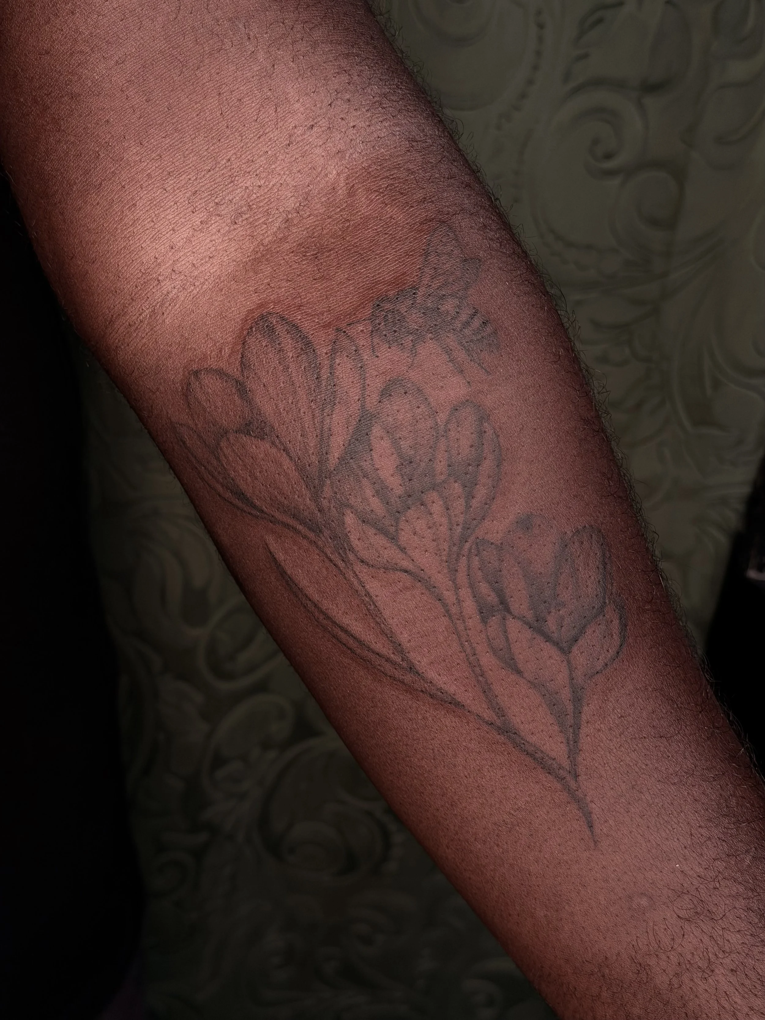 Fineline florals on darker, melanated skin.