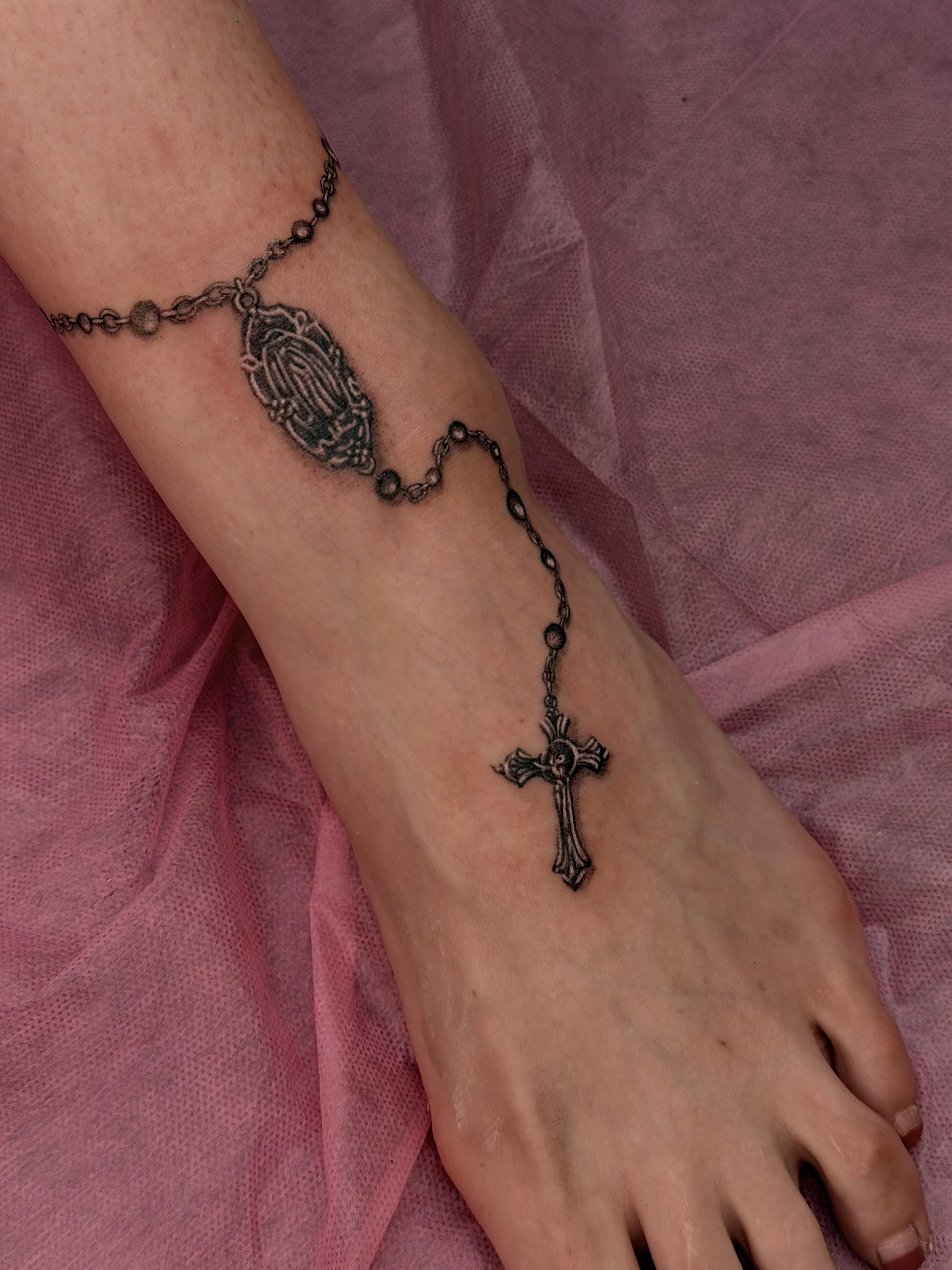 Fineline jewelry rosary ankle tattoo.