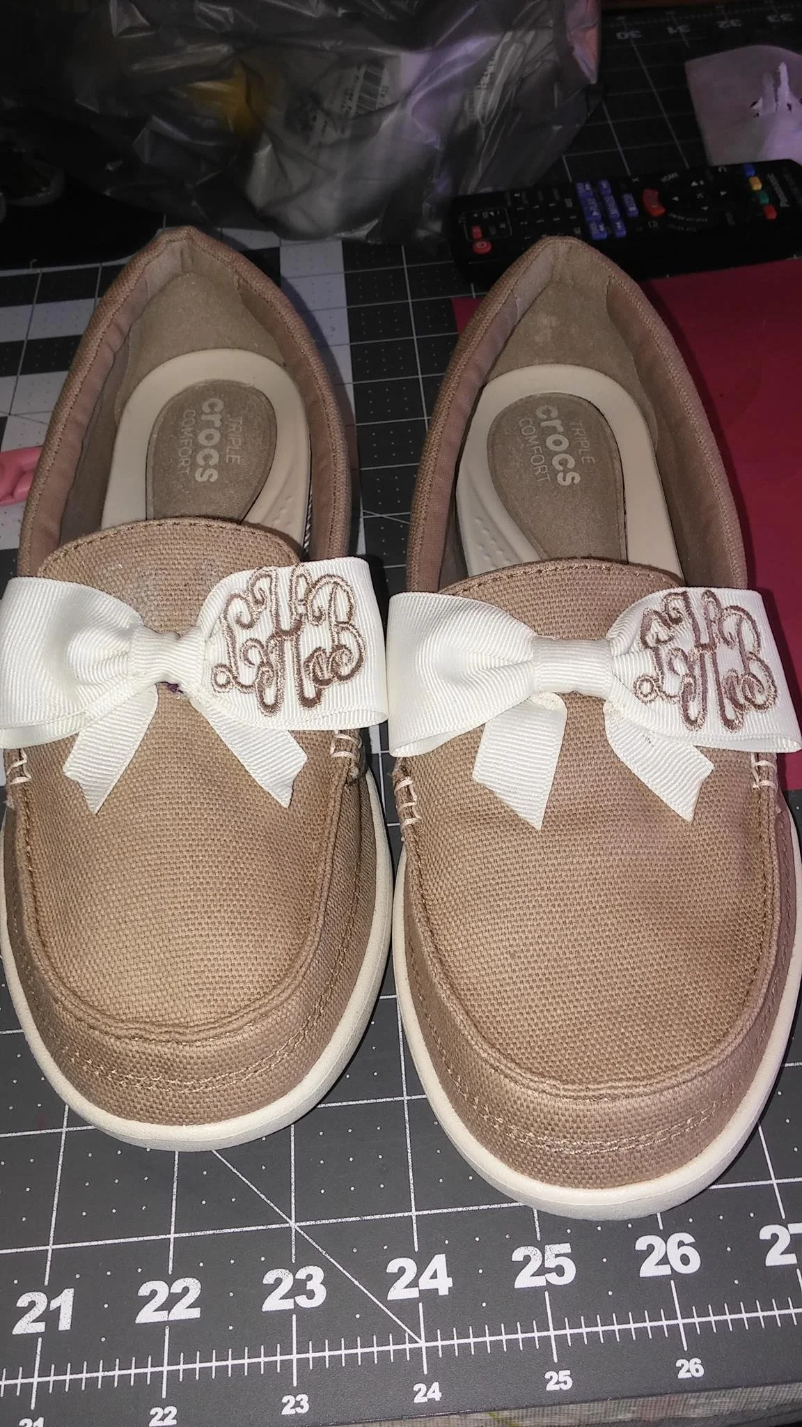 Custom shoes with monogrammed initials on ivory ribbons stitched to the tongue of the shoe.