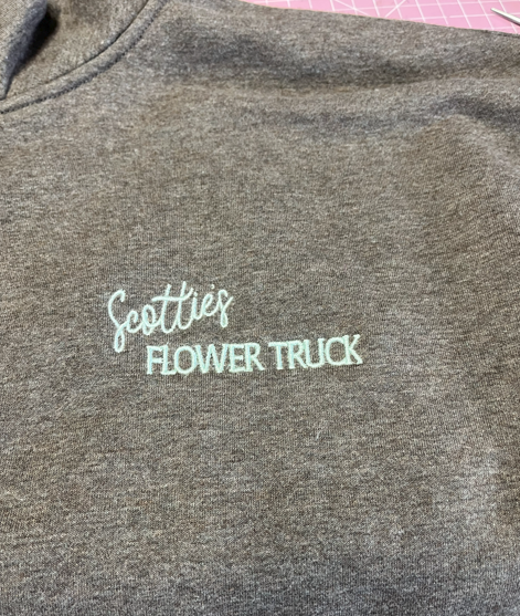 Gray sweatshirt with white embroidered text 'Scottie's Flower Truck