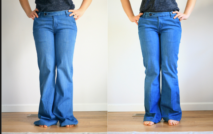 Side-by-side comparison of wide-leg blue jeans on a person with hands on hips, standing on a wooden floor against a plain wall.