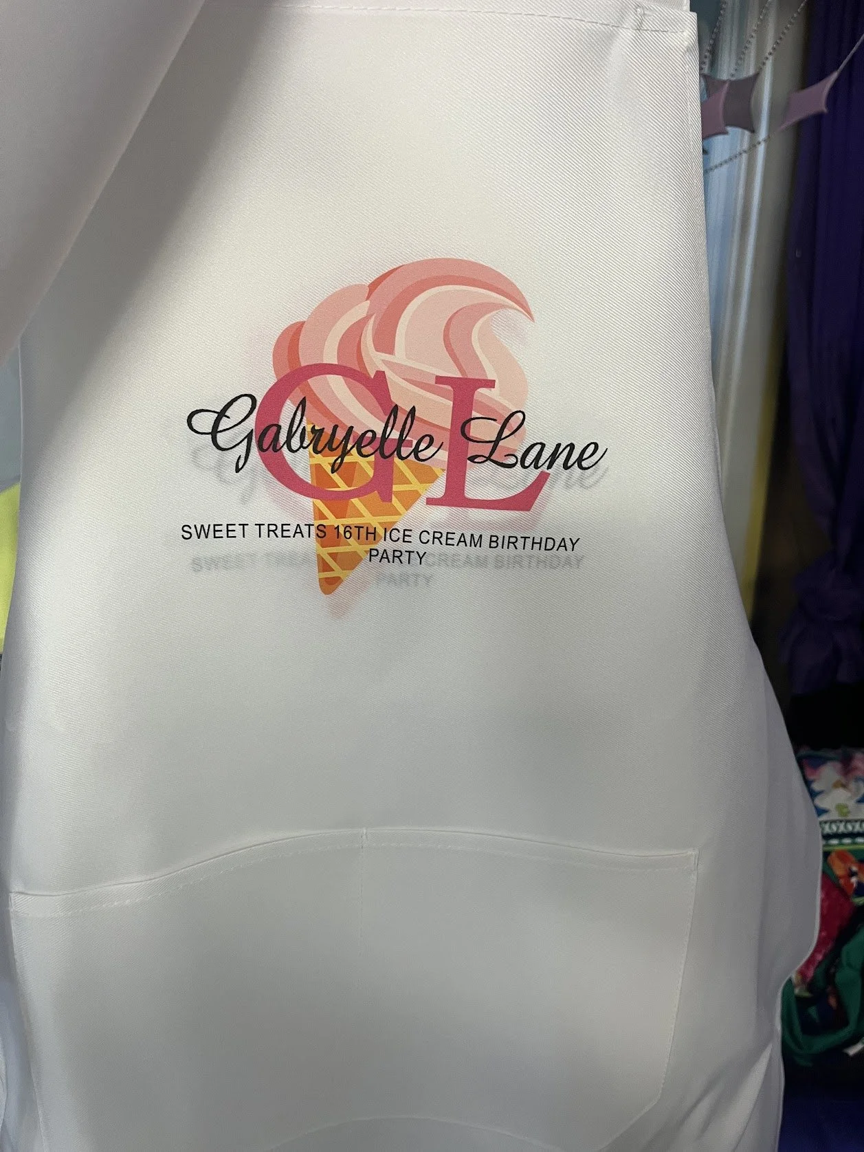 Apron with ice cream cone illustration, personalized with a name, celebrating her 16th birthday with a sweet treats theme.