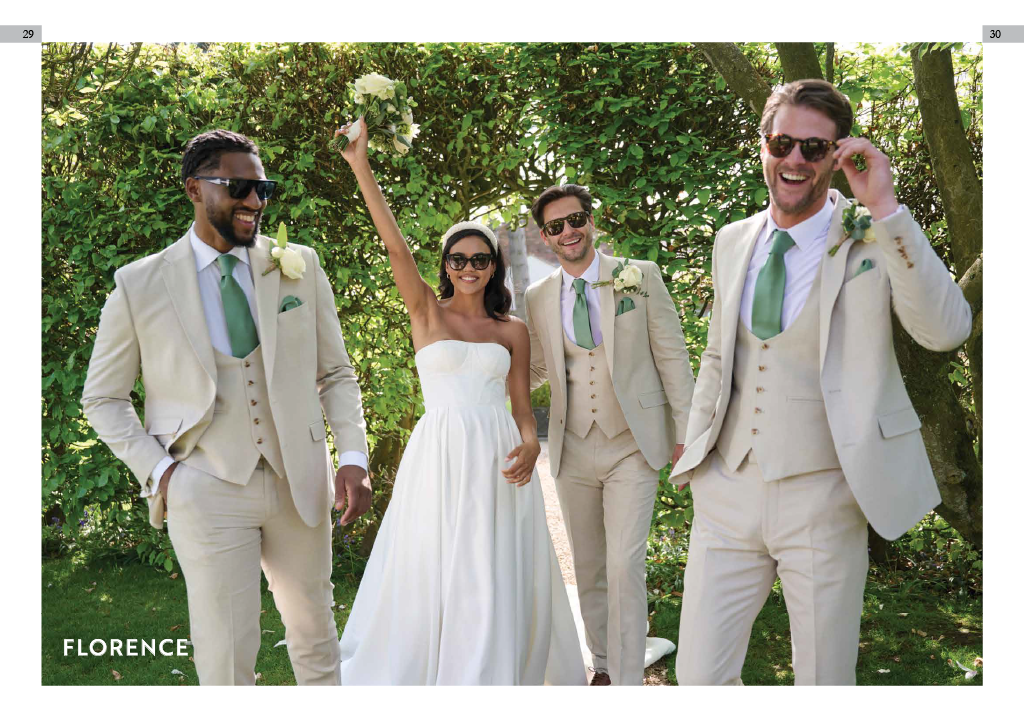 A bride in a white strapless wedding dress holding a bouquet with her arm raised, surrounded by four men in beige suits, wearing sunglasses and smiling outdoors during daytime.