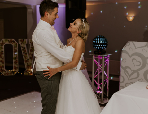 All the sparkle and love of New Year's Eve. Bride and groom dancing and looking at each other with love in their eyes.