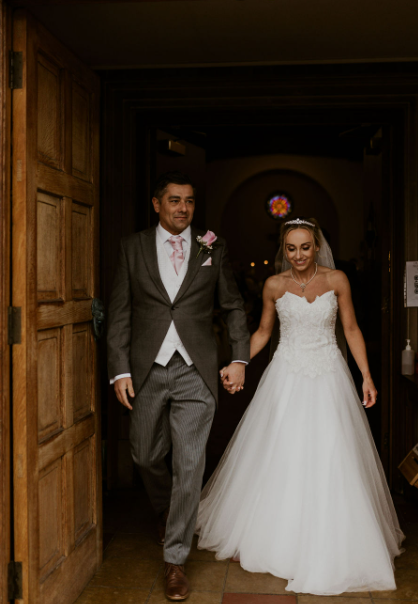 Just Married. The bride and groom walking out of the church, hand in hand. @MollieAnnPhotography