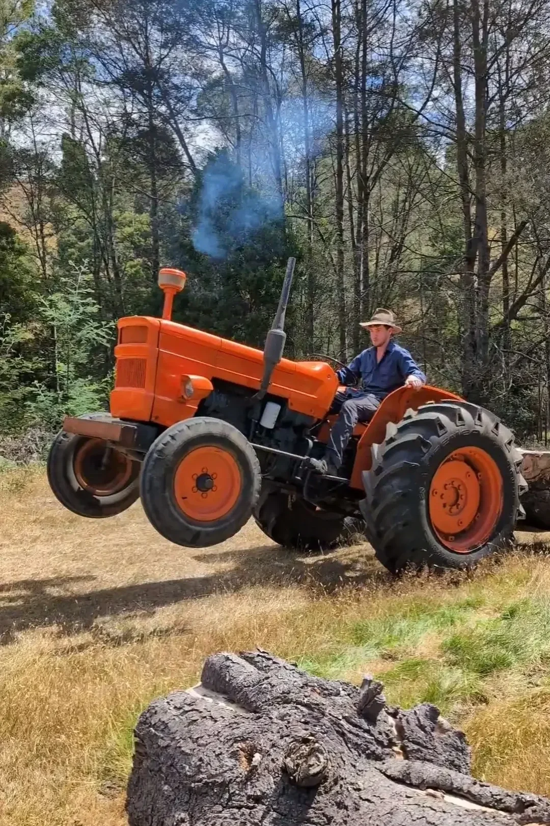 Old tractor lifting milling logs for the construction of Tailrace Sauna