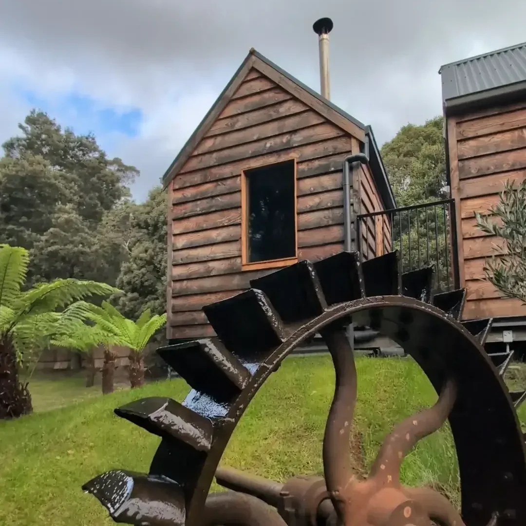 The rustic, private, wood-fired tailrace sauna building is located in the lush bush near Derby, Northern Tasmania