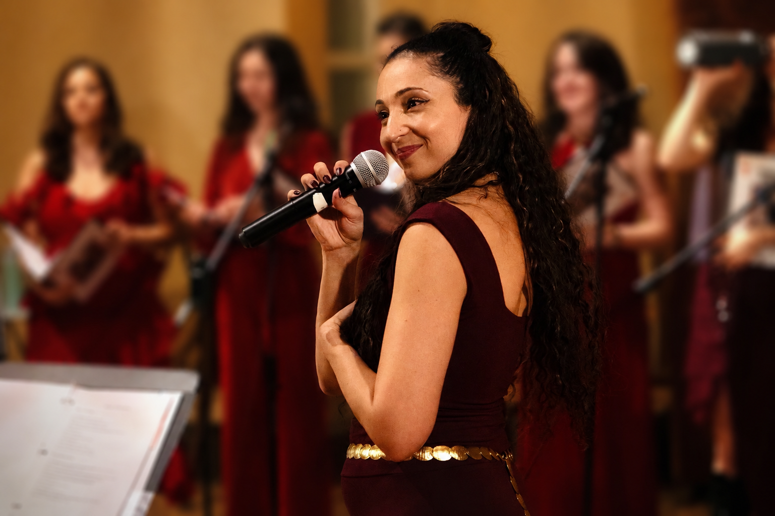 Vocal coach Jessica Sirena directing with choir