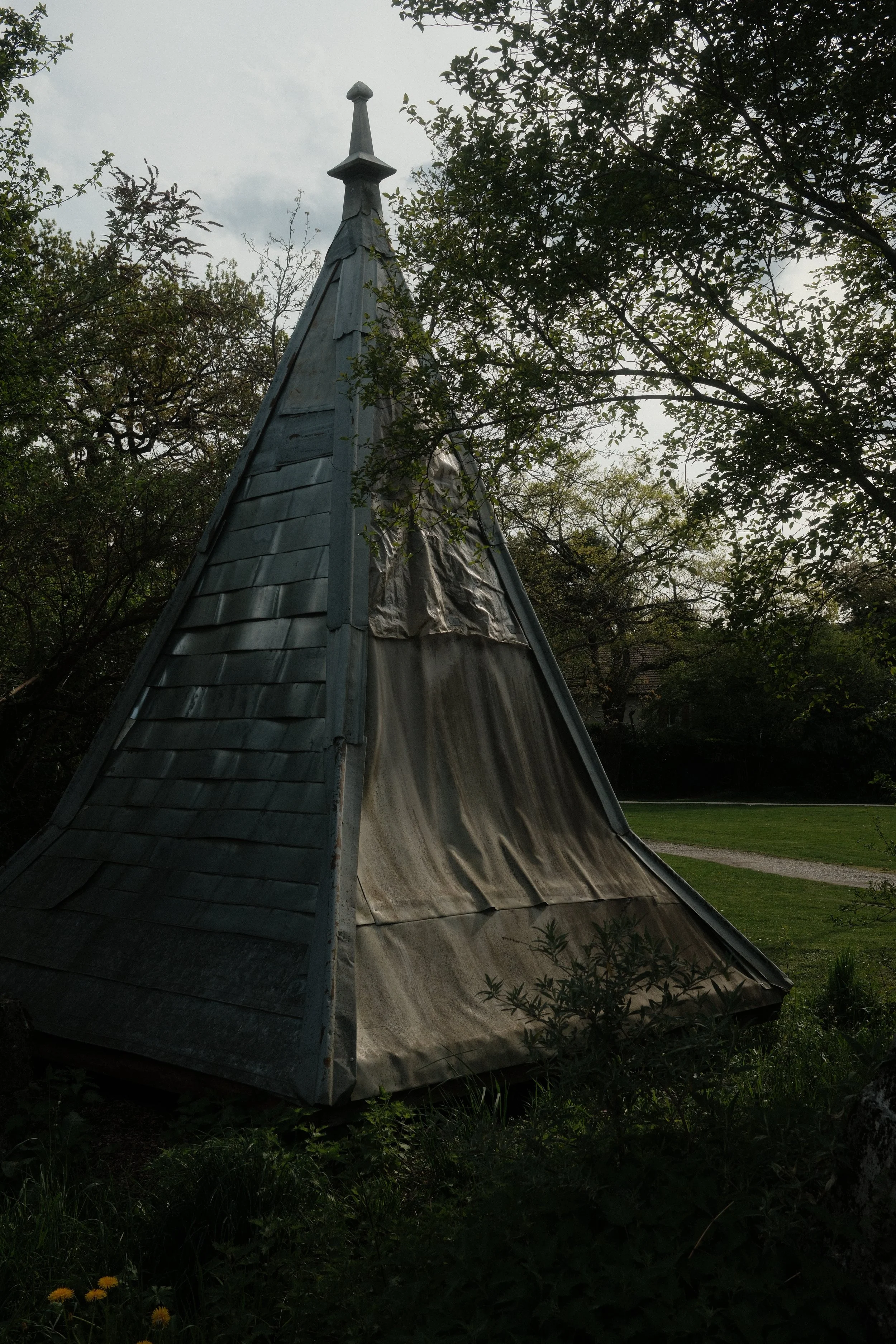 Fine art photography of a lonely architectural structure surrounded by nature under a cloudy sky.