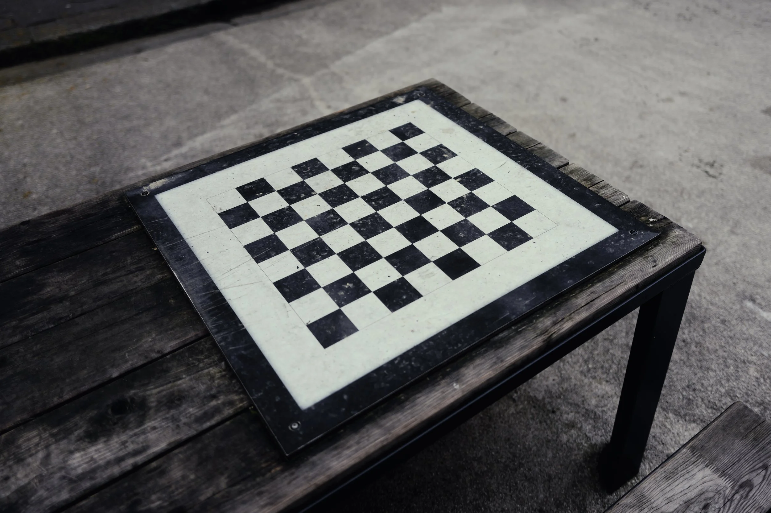 Minimalist still life of a black and white chessboard. Contrast, geometry, and simple rituals in everyday life.