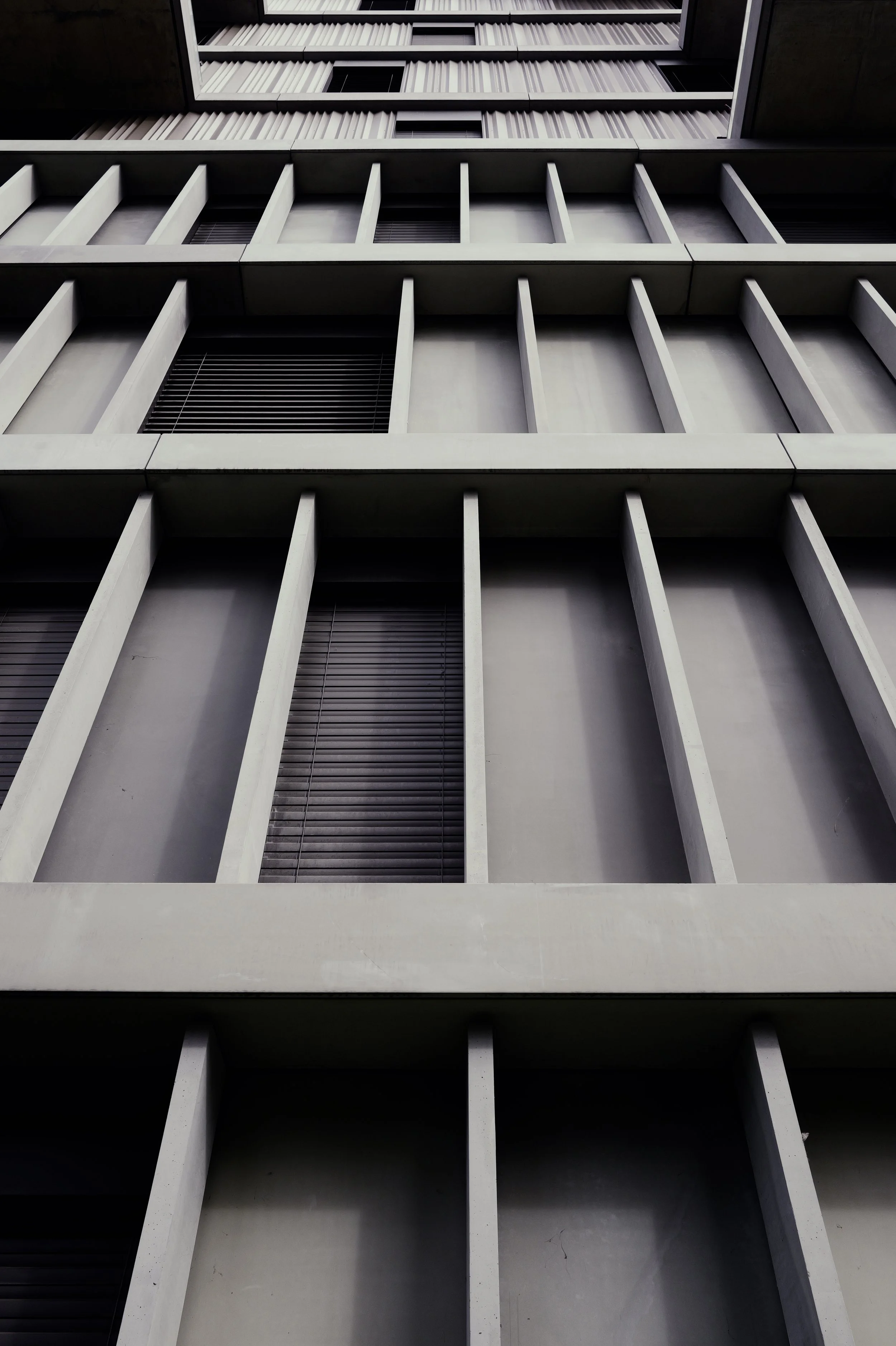 Minimalist architectural photography of a modern building facade with sharp geometric lines and shadows