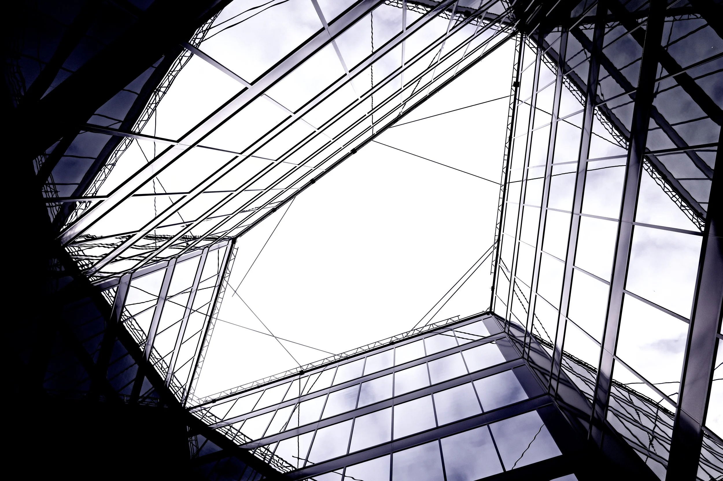 Abstract architecture photography of a modern glass skyscraper looking up, minimalist geometric patterns and lines