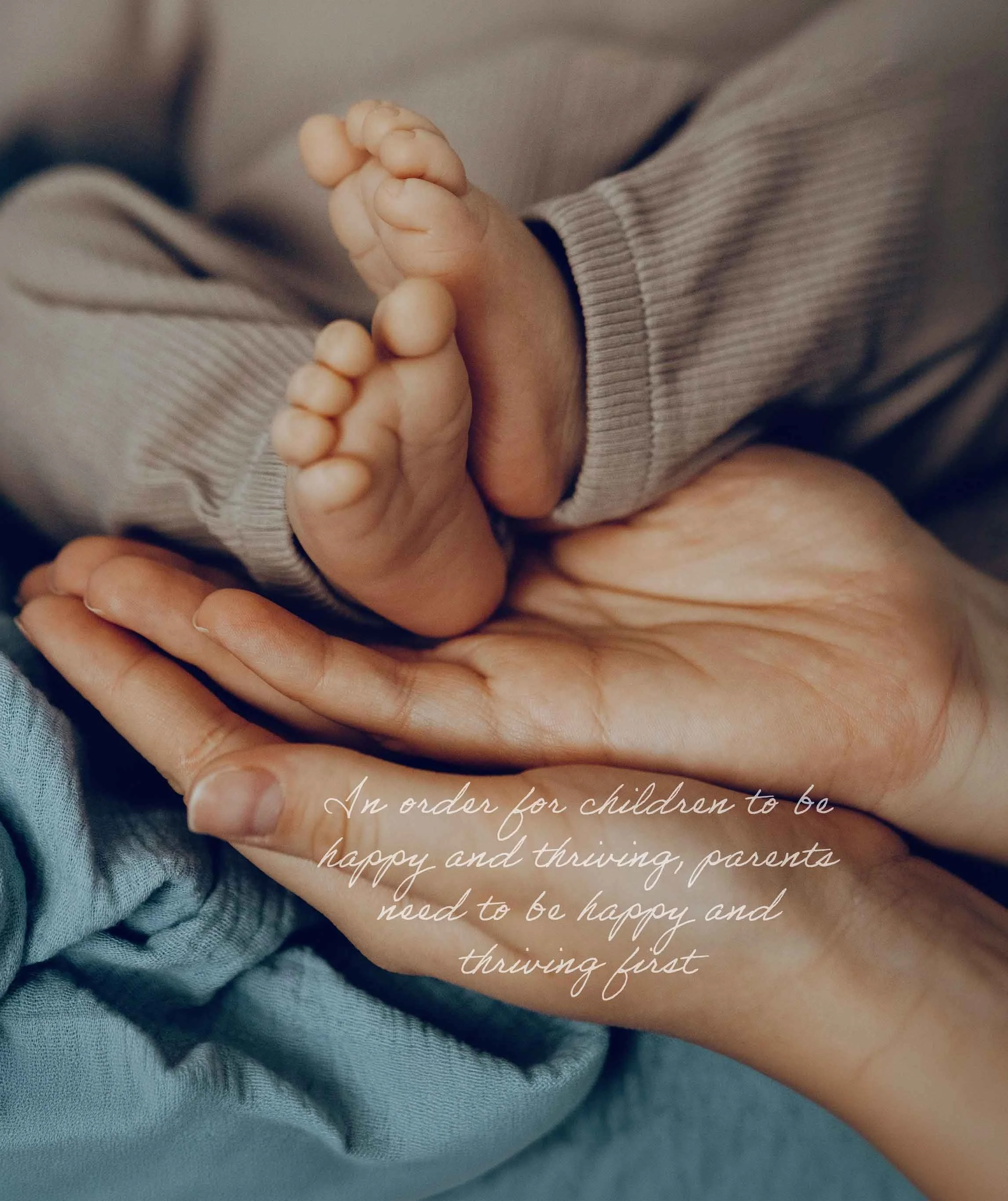 Holistic Parental support. Close-up of a child's foot being held gently by an adult hand, with part of the child's clothing visible. Overlaid text reads: 'In order for children to be happy and thriving, parents need to be happy and thriving first.'