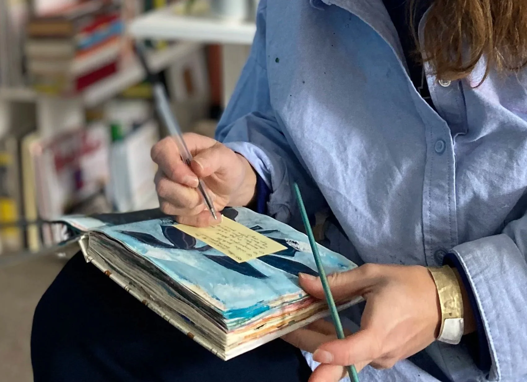 Artist writing painting drawing in sketchbook art mixed media