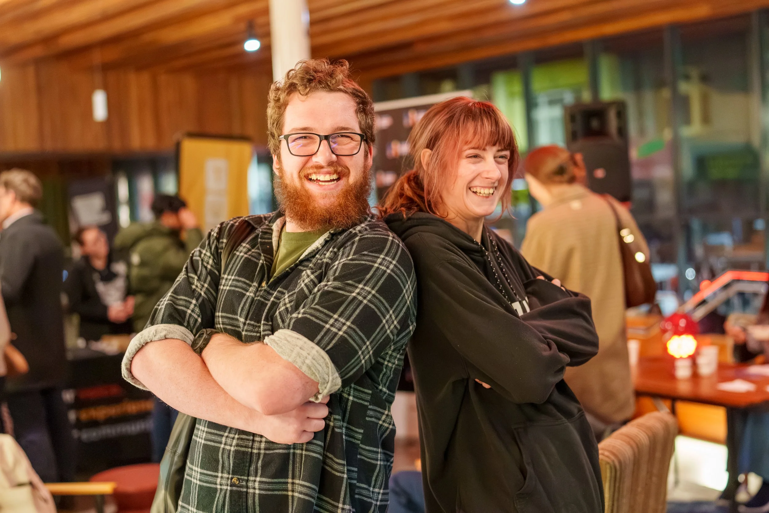 2 students posing with arms folded and smiling