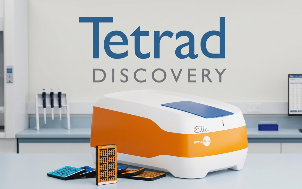 A laboratory setting with a white and orange Tetrad Discovery Simple Plex machine on a countertop, surrounded by microfluidic chips, and laboratory equipment in the background.