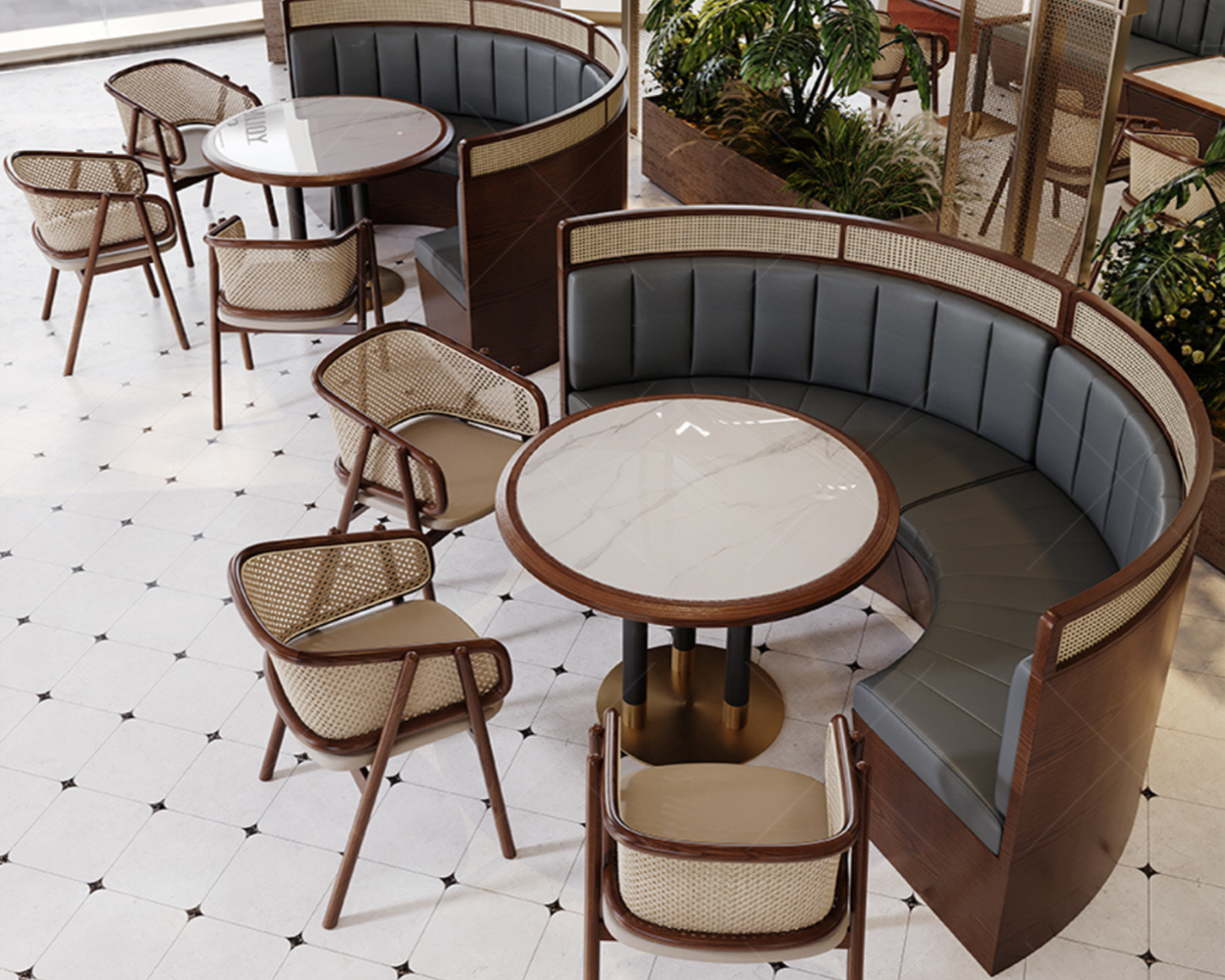Empty seating area with round marble tables, chairs with cream cushions, and curved booths with leather upholstery, in a stylish indoor space with tiled floor and lush green plants.