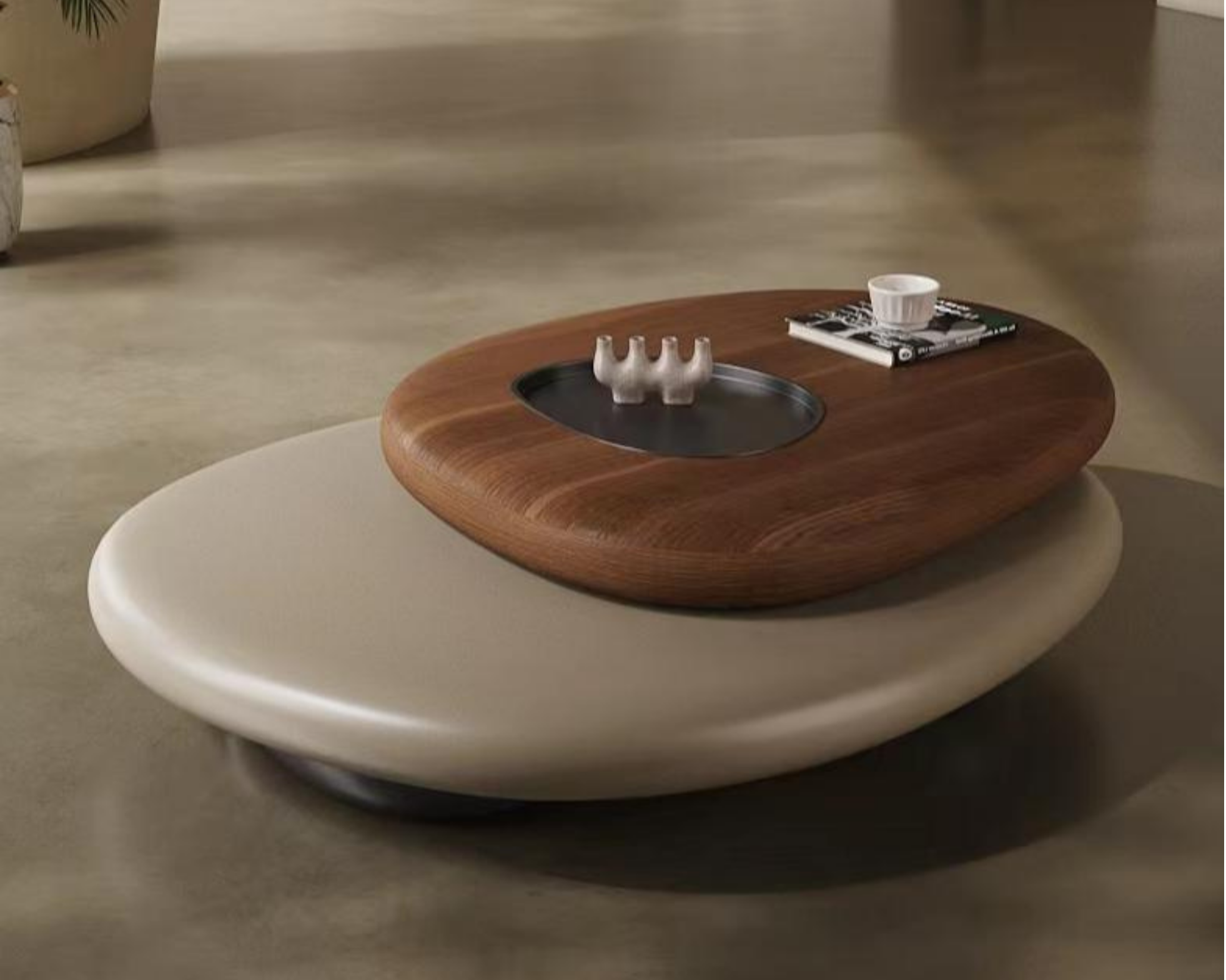 A modern coffee table with a wooden tray holding a book, a small ceramic dish, and three small figurines; part of a white round table is visible in the foreground.