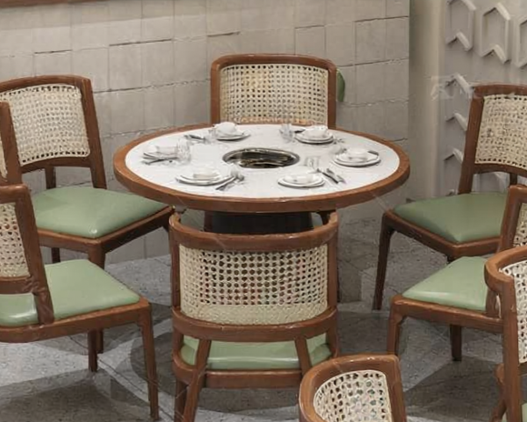 Round dining table with six place settings and upholstered chairs in a restaurant or dining room.