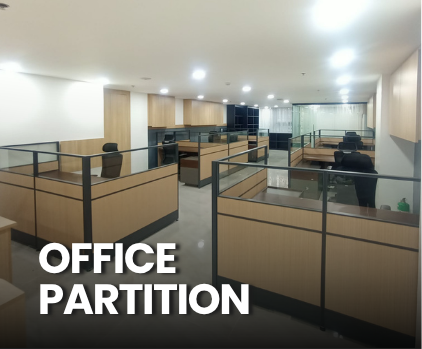 An empty modern office with wooden partitions and black chairs, divided into cubicles with glass and wood barriers.