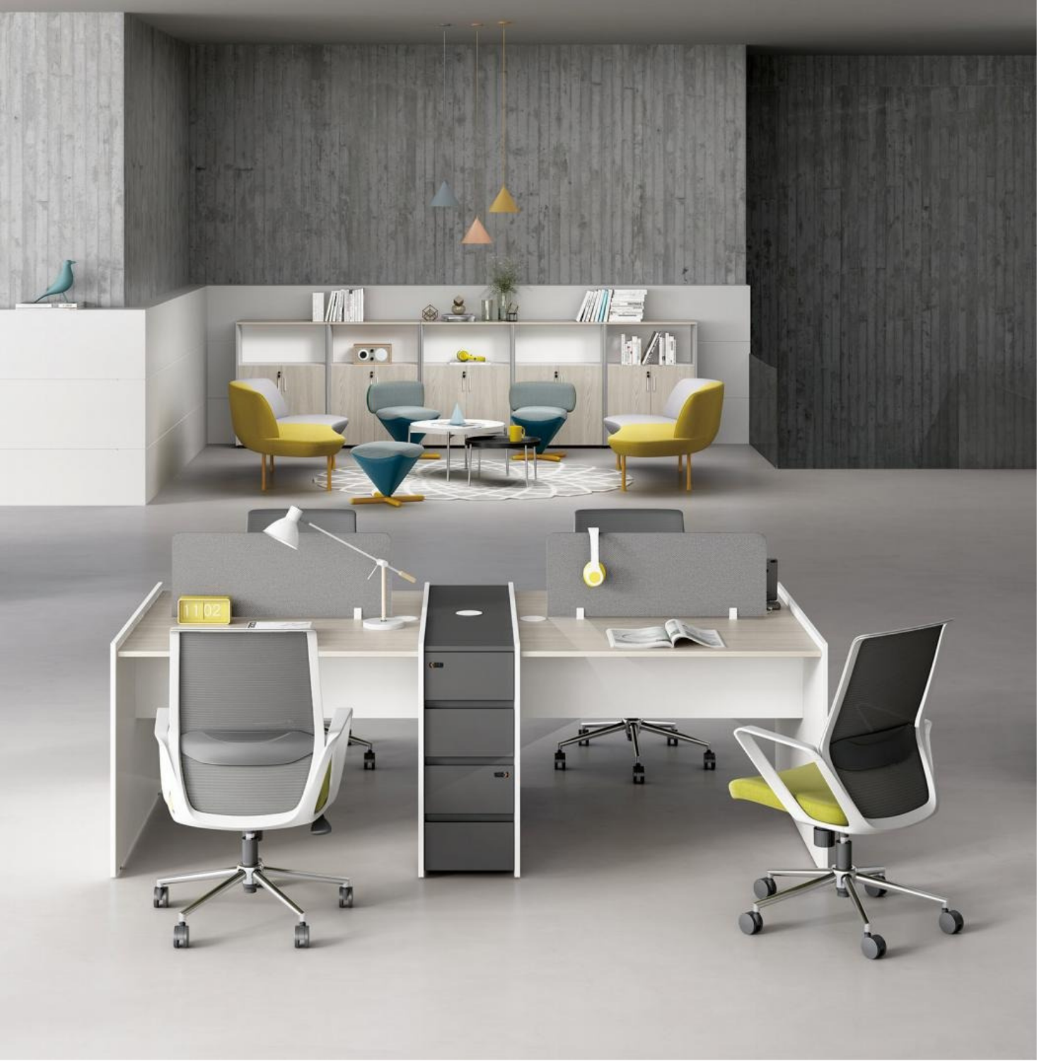 Modern open-plan office with white desks, rolling chairs, and a lounge area with yellow and blue chairs against a gray concrete wall.