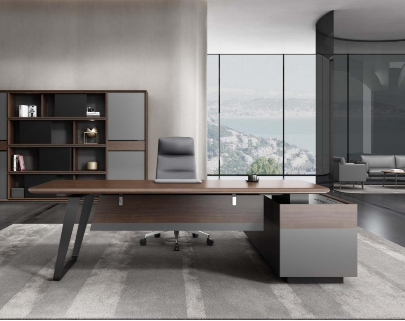 Modern office with a large wooden desk, gray ergonomic chair, bookshelf, and floor-to-ceiling windows showing a city and water view.