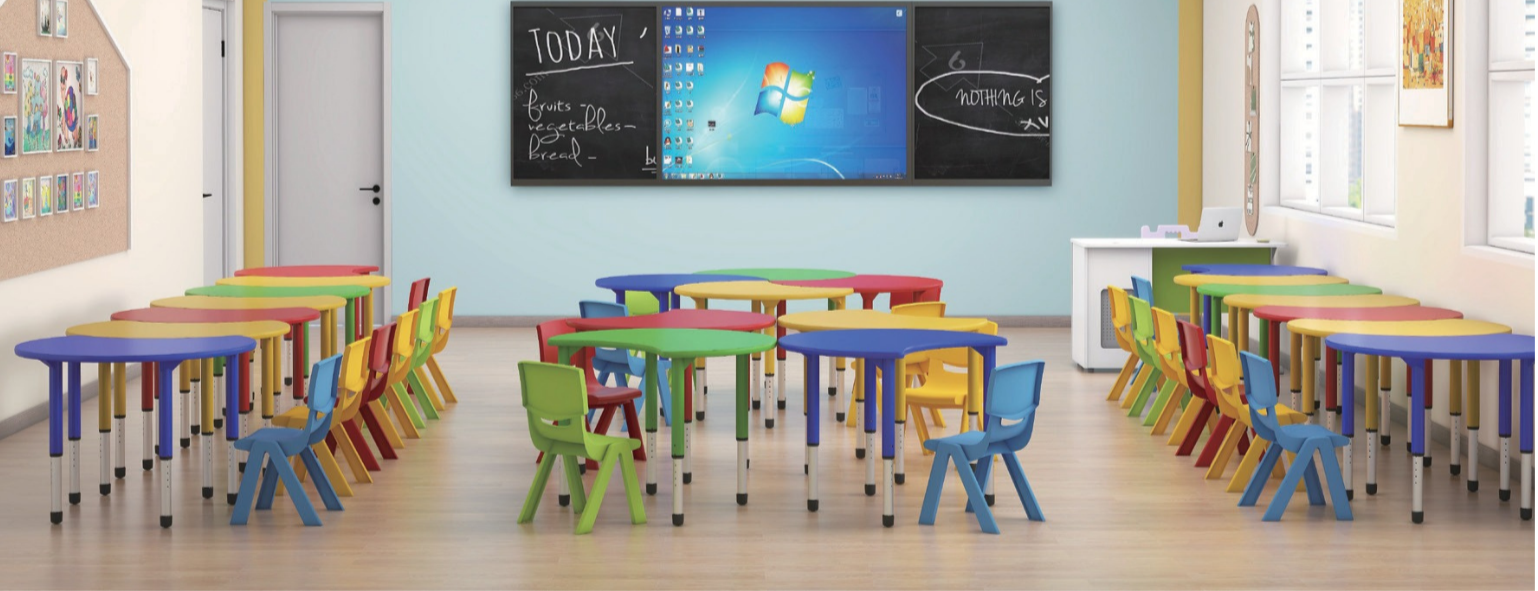 Colorful classroom with small tables and chairs, a blackboard, and windows showing outside light.