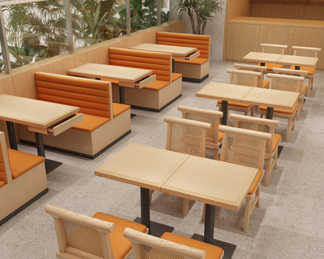 Dining area with wooden tables, orange booth seating, and light wood chairs with orange cushions, located near large windows and indoor plants.