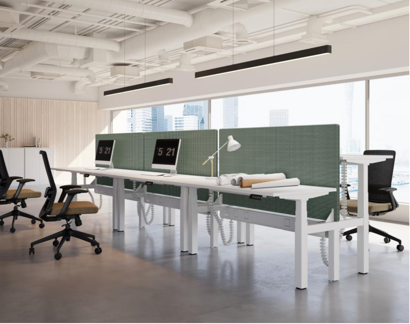 Modern office workspace with white desks, partition screens, monitors showing the time 5:21, black and beige office chairs, desk lamp, and urban cityscape visible through large windows.