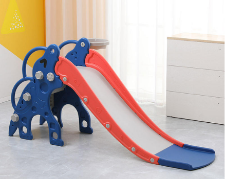 Small indoor slide in a room with yellow wall and white curtains.