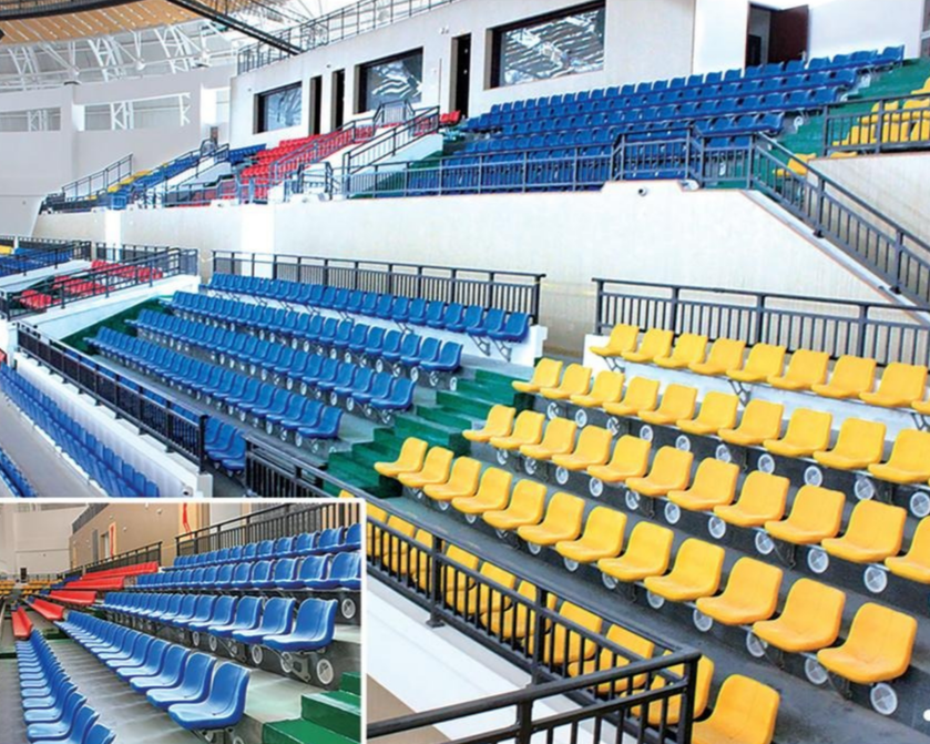 Sports arena with tiered seating in blue, yellow, and red seats.