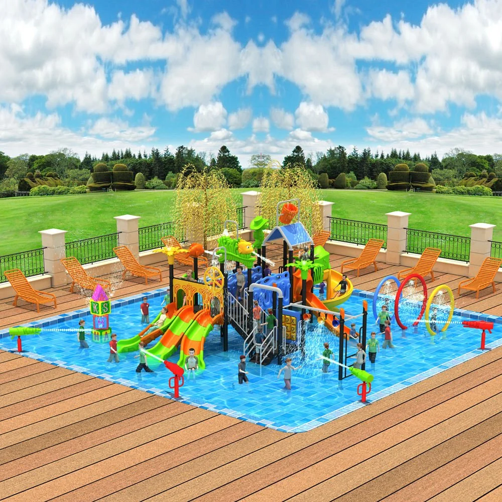 A colorful splash pad with multiple kids playing, featuring slides, water sprays, and rings, surrounded by lounge chairs on a paved area, with a green field and trees in the background under a partly cloudy sky.