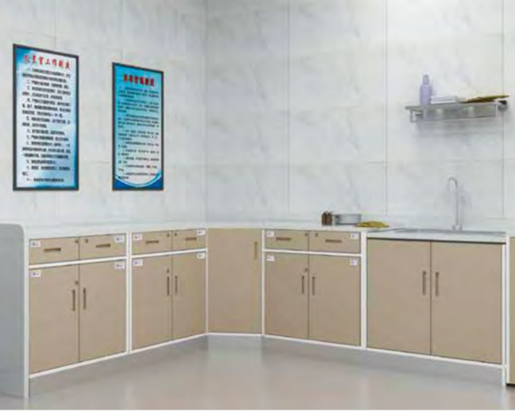 Hospital or medical clinic kitchenette with beige cabinets, a sink, soap dispenser, and informational posters on the wall.