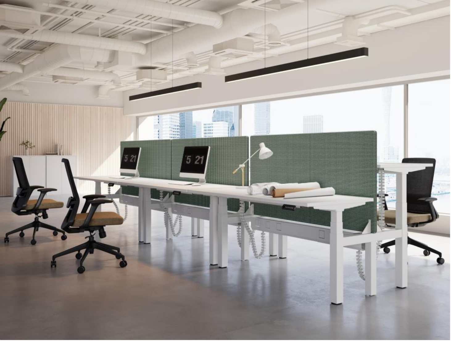 Modern office space with white desks, green dividers, black and beige office chairs, computers, a desk lamp, blueprints, and panoramic city view through large windows.