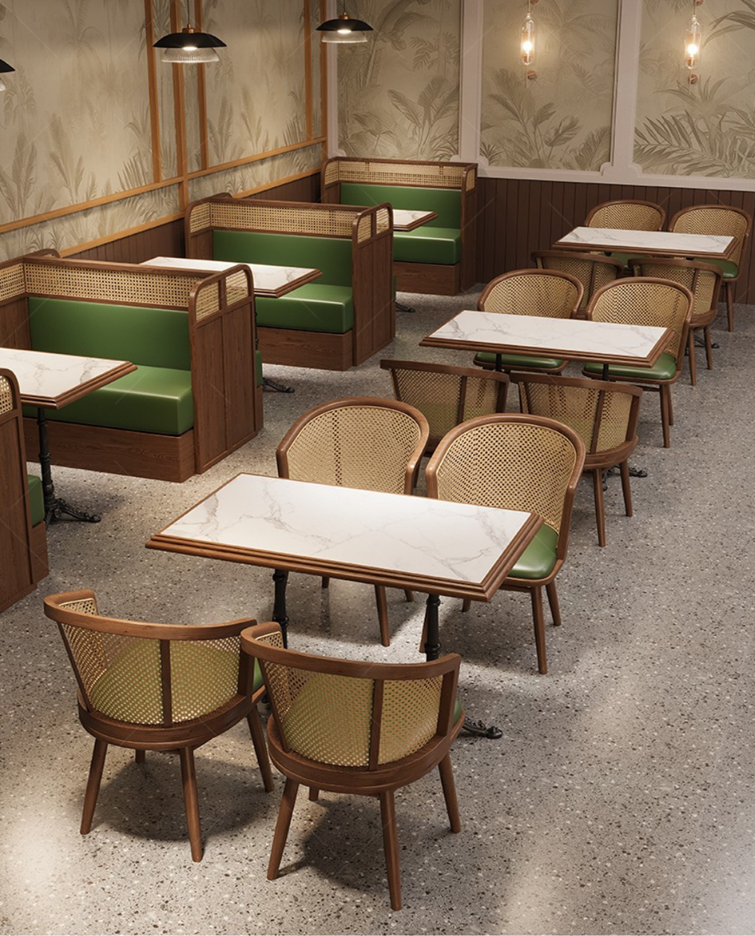 Empty restaurant dining area with wooden chairs with green cushions and marble-patterned tables, beige and green booth seating, wallpaper with botanical leaf pattern, and hanging pendant lights.