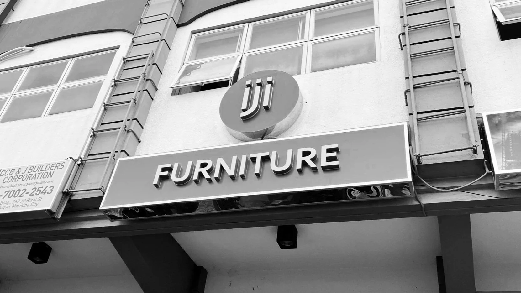 A sign for a furniture store with the logo 'jiji' above it, on a building exterior.