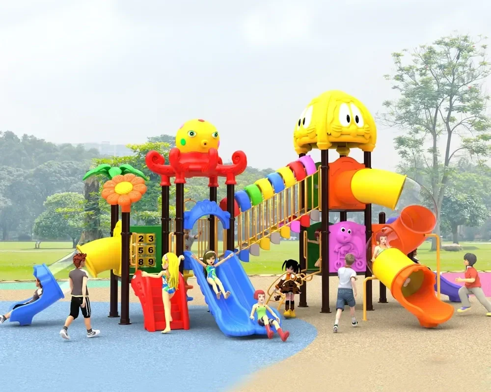 Colorful playground structure with slides, tunnels, and climbing areas, surrounded by children playing and adults supervising in a park