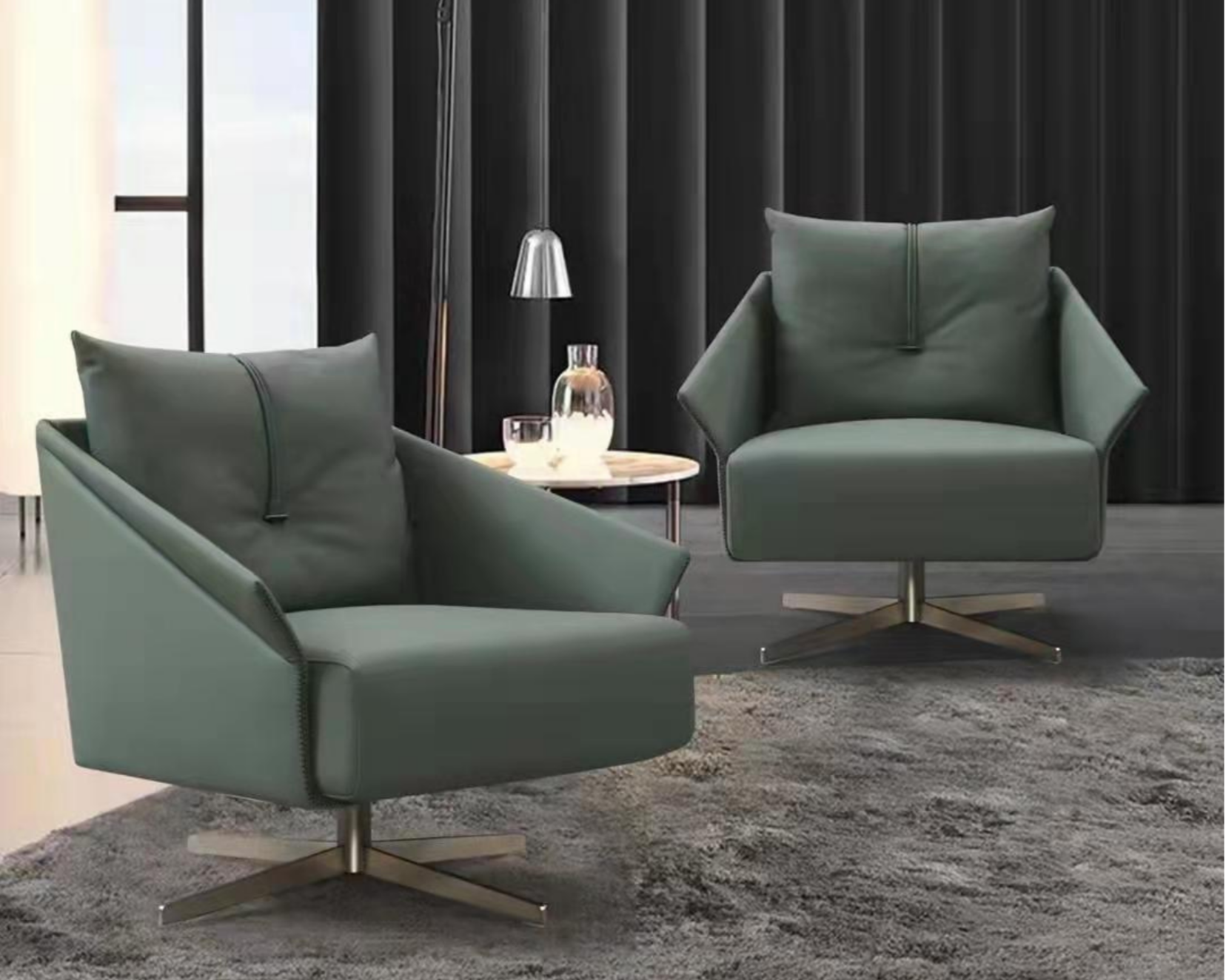 Modern living room with two green armchairs, a small round white table, a glass pitcher, and glasses, set against a backdrop of black curtains and a light-colored wall.
