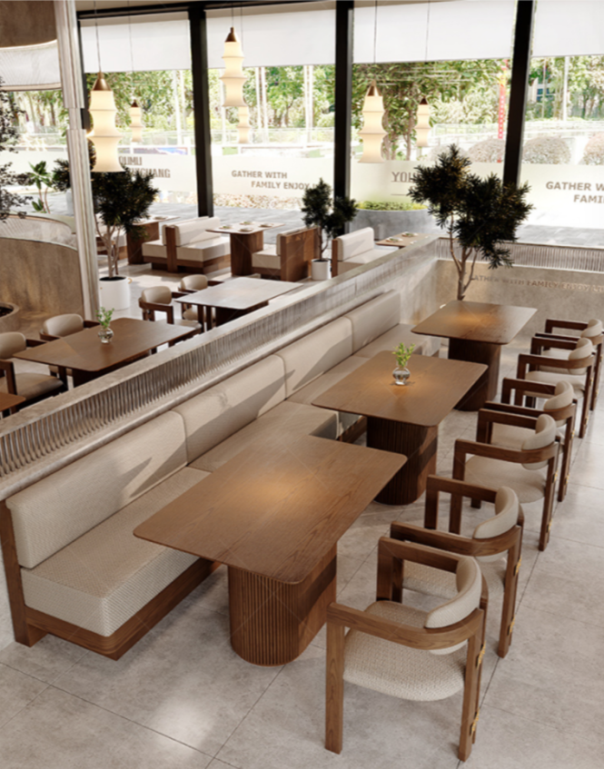 Modern restaurant interior with wooden tables, beige upholstered seating, and potted plants near large windows.