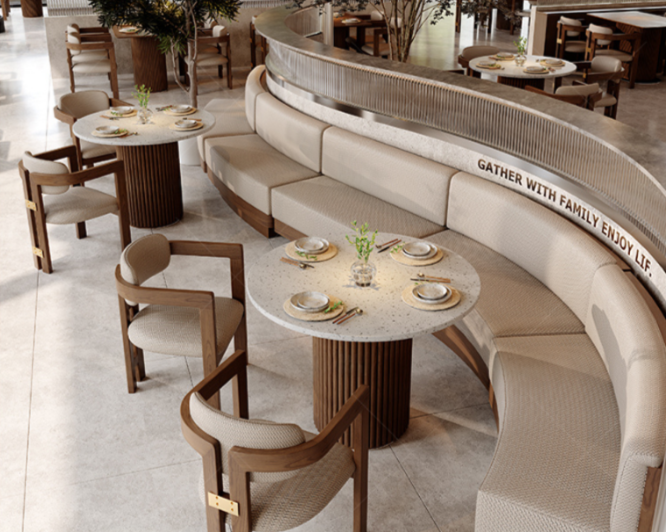 Elegant restaurant with round tables, beige chairs, and a curved sofa with a message about family and life.