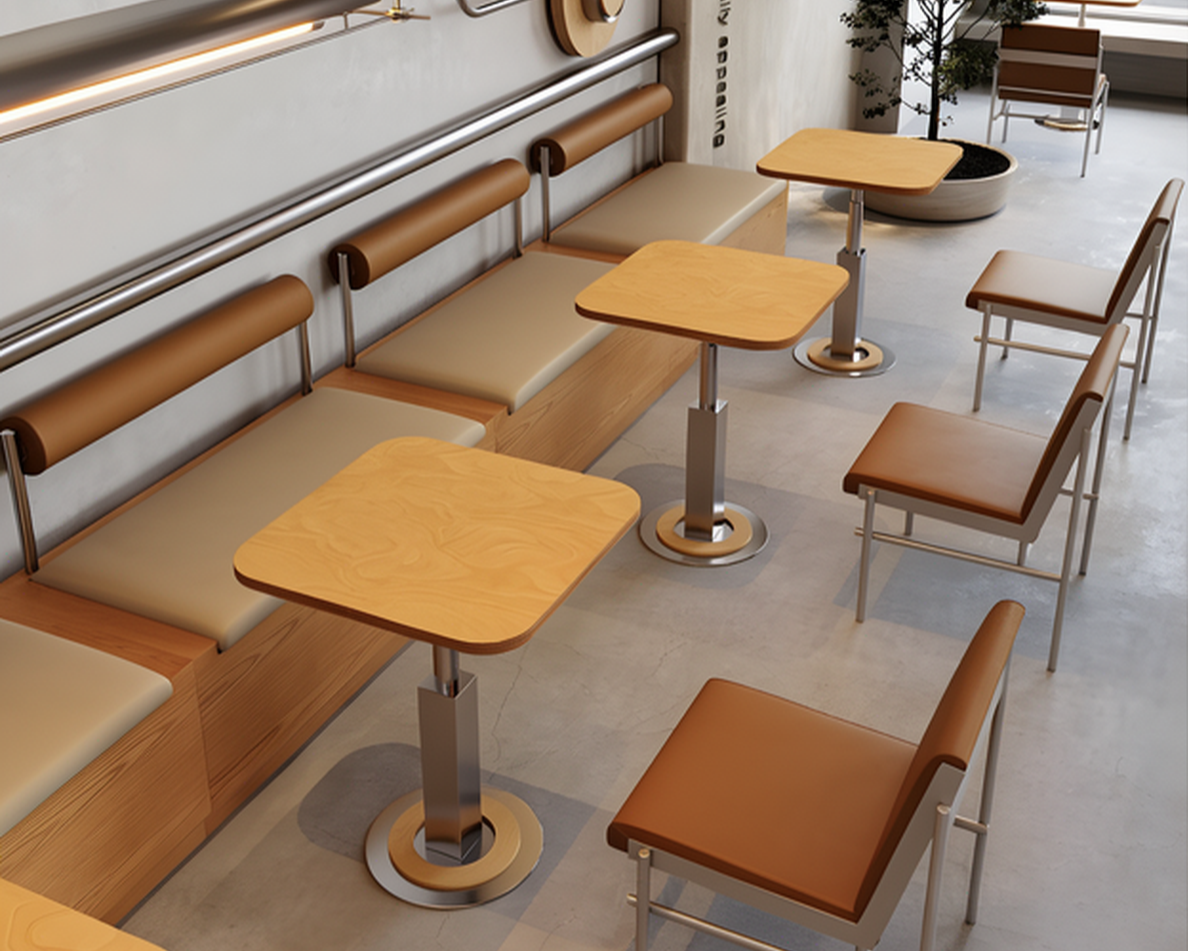 Empty seating area in a modern cafe with wooden tables, brown cushioned chairs, and a beige cushioned bench along the wall.