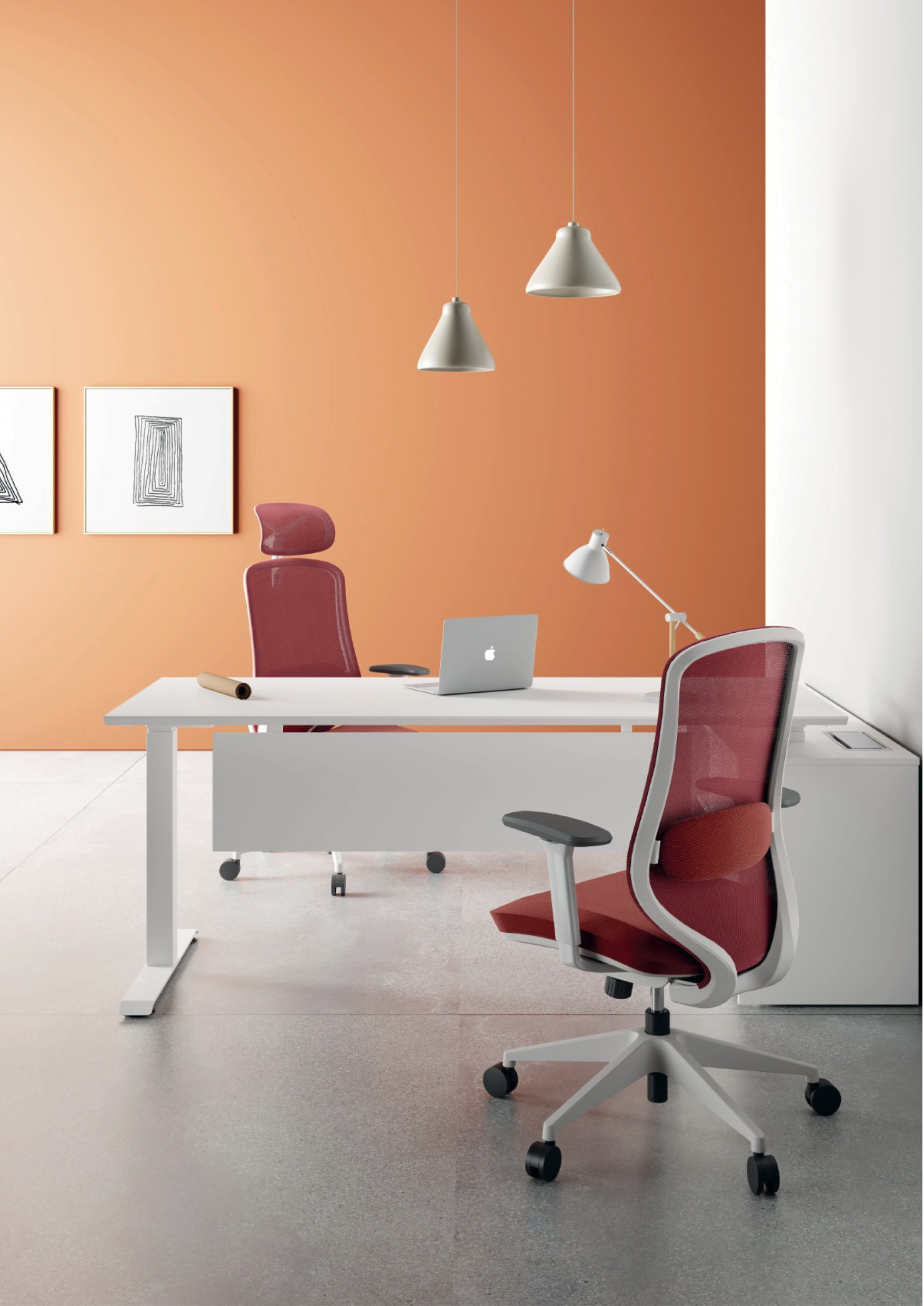 Modern office with white desk, red chairs, desk lamp, laptop, hanging pendant lights, and framed artwork on beige wall.