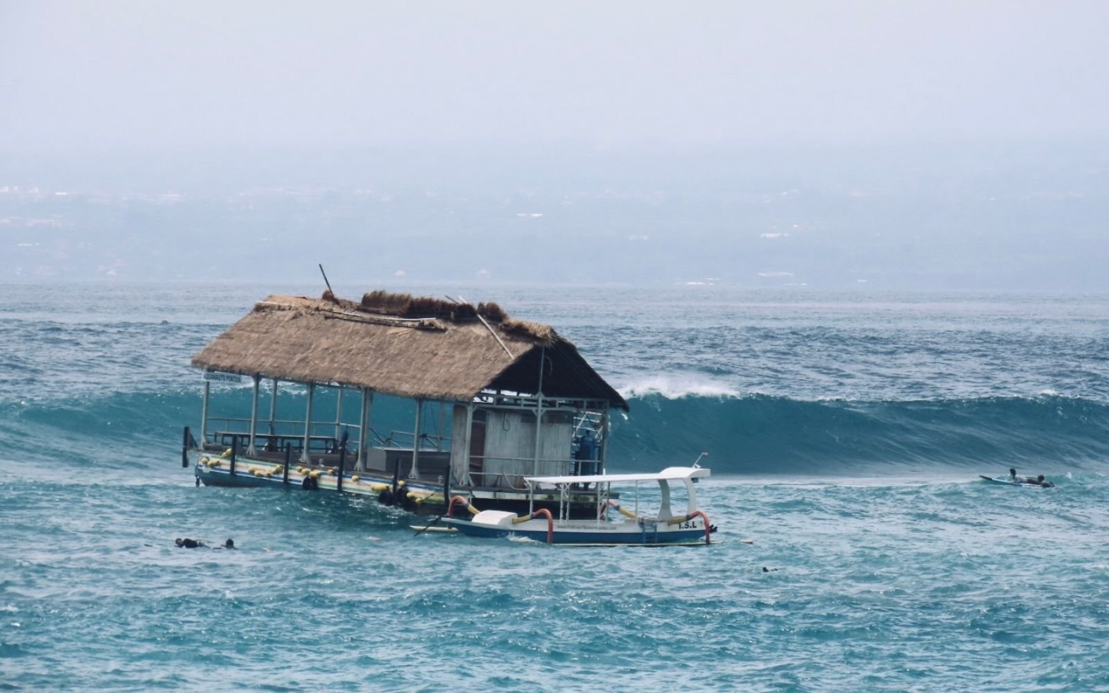 Surfers at Lacerations surf break, Nusa Lembongan