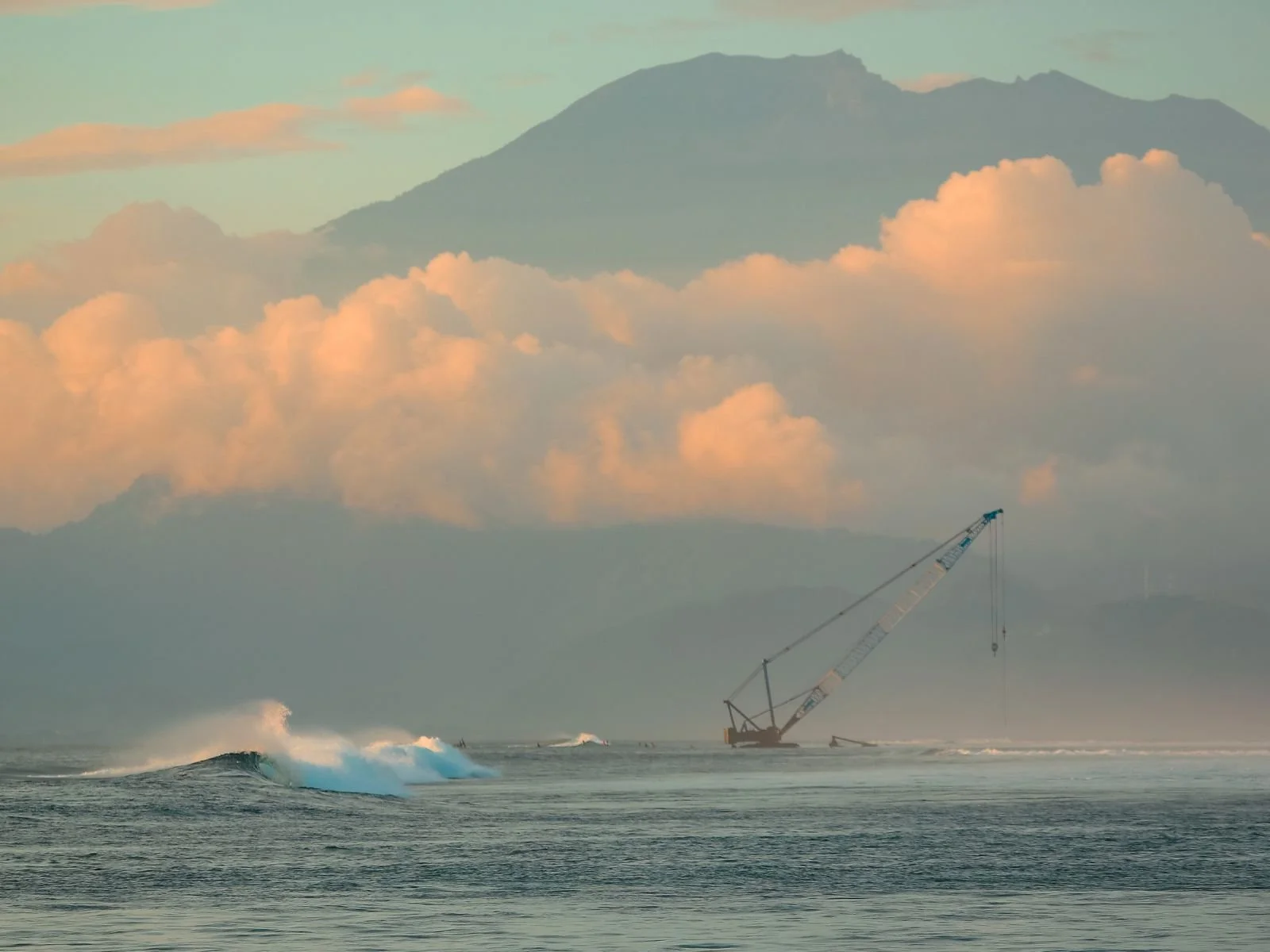 Shipwrecks surf break with Mount Agung in the distance